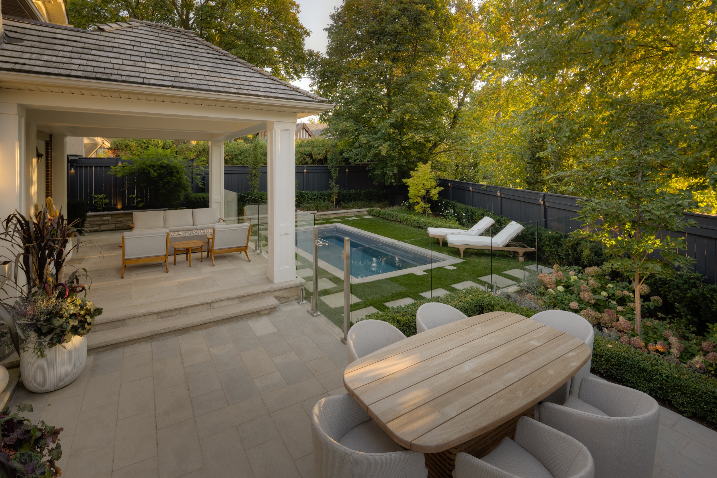Urban Backyard with pool, covered porch seating area and patio dining table and chairs